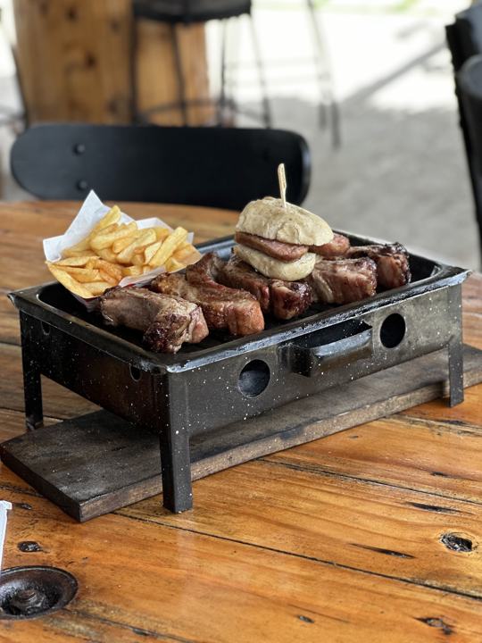 Grill board with fries and a burger